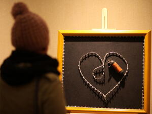 A woman visits the exhibition 'Chic-Art-Resistance' by Palestinian artist Sami Musa in the West Bank city of Ramallah, on December 10, 2013.  [AFP]