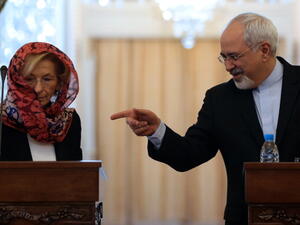 Iranian Foreign Minister Mohammad Javad Zarif  gestures towards his Italian counterpart Emma Bonino as they give a joint press conference in Tehran on December 22, 2013. [Getty Images]