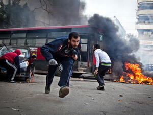 Supporters of Egypt's deposed president Mohamed Morsi run for cover from tear gas fired by riot police during clashes in the northeastern part of Cairo's Nasr City district on January 3, 2014. [Getty Images]