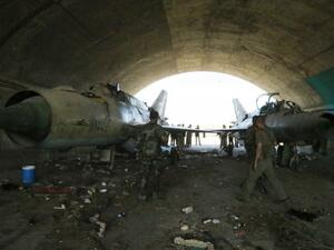 Syrian soldiers look at the damage of a hanger in central Homs. (AFP photo)