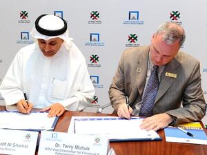 Abdullatif Al Shamsi, Managing Director of IAT and Terry Motiuk, Vice Chancellor of Abu Dhabi University during the signing