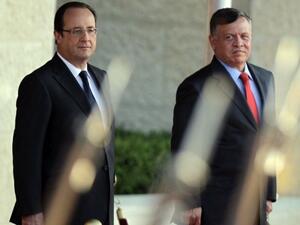 Jordan's King Abdullah and French President Francois Hollande at Al-Hummer Royal Offices in Amman on Sunday. (AFP)