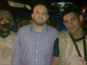 Ahmed Arif is seen smiling with the police that arrested him. (Egyptian police Facebook)