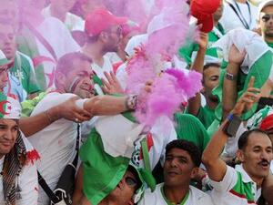 Algeria's supporters cheer their team during the FIFA 2014 World Cup qualifying football match between Burkina Faso and Algeria on October 12, 2013 in Ouagadougou. (AFP, Farouk Batiche)
