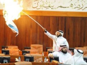 Osama Al Tamimi sets the Israeli flag on fire in Parliament.