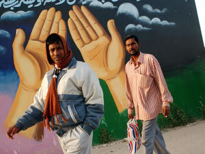 Immigrants standing by a mosque in Kuwait. 