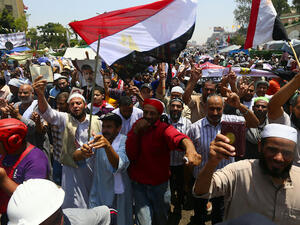  Supporters of Egypt's deposed president Mohamed Morsi chant islamic slogans during a rally outside Cairo's Rabaa al-Adawiya mosque on July 13, 2013. (Source: AFP/MARWAN NAAMANI)