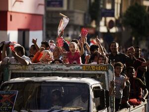 Egyptians shout slogans as they drive through the streets of Cairo on their way to join thousands protesting against President Mohamed Morsi and the Muslim Brotherhood at Tahrir Square on Sunday. (AFP)
