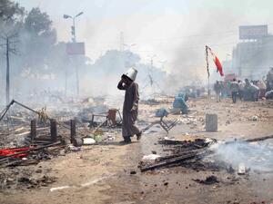  supporter of Egypt's ousted president Mohamed Morsi walks through the debris following clashes with police in Cairo on August 14, 2013. (AFP)