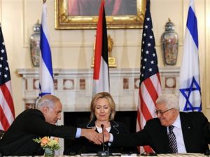 2010 US Secretary of State Hillary Clinton (C), looks on as Prime Minister Benjamin Netanyahu of Israel (L) and President Mahmoud Abbas of the Palestinian Authority (R) shakes hands as they re-launch of direct negotiations between Israeli and Palestinian Authority at the State Department in Washington, DC, on September 2, 2010