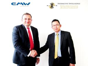 EMW CEO and Interactive Intelligence Territory Manager shake hands after the signing