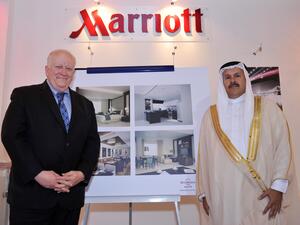 Ed Fuller and Shaikh Hisham Abdulrahman Al-Khalifa beside the renderings of The Residence Inn by Marriott Juffair