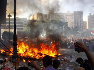 Opponents of Egyptian President Mohamed Morsi burn the content of a Freedom and Justice Party office in the coastal city of Alexandria on June 28, 2013. One person was killed and more than 70 injured in Egypt's second city of Alexandria on Friday as clashes raged between supporters and opponents of Islamist President Mohamed Morsi, state media reported. (Source: AFP)