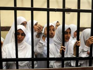 Female members of the Muslim Brotherhood are seen during their trial in the Egyptian city of Alexandria on November 27, 2013. Seven of the 21 arrested are aged between 15-17. (AFP)