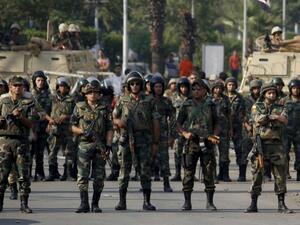 Egyptian army's soldiers stand guard in Cairo's eastern Nasr City district on October 11, 2013, as supporters of Egyptian ousted president Mohamed Morsi demonstrate against the military. (AFP)