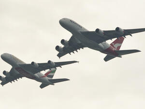 To celebrate the link-up, Emirates and Qantas staged a tandem flyover of the Sydney Harbour Bridge by two Airbus A380s. (JAMES MORGAN / QANTAS / AFP)
