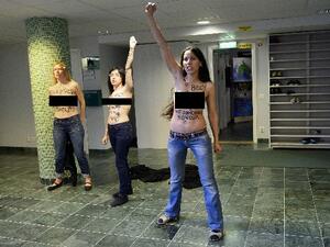 Egyptian activist Aliaa Elmahdy (C) and other members of feminist group FEMEN stage a topless protest  inside a Mosque in Stockholm, Sweden on Saturday (AFP)