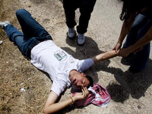 A Gaza teen falls, shot and injured by Israeli fire: Image used for illustrative purposes