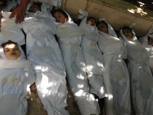 A handout image released by the Syrian opposition's Shaam News Network shows bodies of children wrapped in shrouds laid out on the ground as Syrian rebels claim they were killed in a toxic gas attack by pro-government forces in eastern Ghouta, on the outskirts of Damascus on August 21, 2013. (AFP/HO/Shaams News Network)