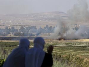 Two Israeli druze women sit looking over the clashes between Syrian forces in the Golan Heights on Thursday. AFP Photo
