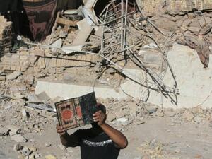 An Iraqi man retrieves a copy of the Koran from the debris of the Al-Hussein mosque following an explosion in the district of al-Musayyib, south of Baghdad on Monday. The Islamic State of Iraq and the Levant on Tuesday claimed responsibility for the attacks. (AFP)
