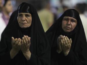 Muslim Shiites women pray during the ceremony commemorating the birth of Imam Mehdi, the 12th holiest figure for Shiite Muslims. in Karbala on Monday. Several bombs targeted Shiites on Monday evening, as sectarian violence grows. (AFP)