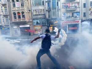 A protestor throws back a canister of tear gas to Turkish riot policemen during a protest against the demolition of Taksim Gezi Park on Friday.  AFP Photo
