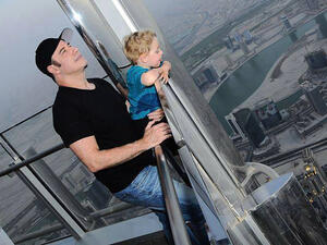 John Travolta and son survey the Dubai view atop the observation deck at Burj Khalifa. (Image: Facebook)