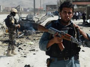 Afghan security forces stand guard at the site of a suicide attack near Kabul military airport in Kabul on Monday. AFP photo
