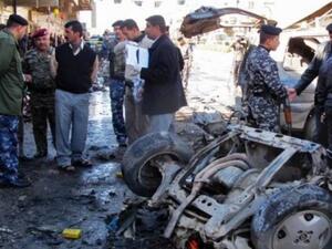 Police inspect the aftermath of a car bomb in Kirkuk