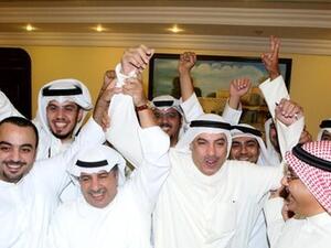 Liberals, who were not represented in the previous parliament, won three seats in the elections. Here, they celebrate in Kuwait City on Sunday morning. (AFP)