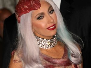 Dressed for the media sharks: Lady Gaga wears meat for MTV music. Gaddafi also always dressed for the kill.