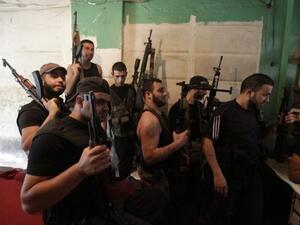 Lebanese Sunni militia men hold a meeting in the Sunni district of Bab Al Tabbaneh in Lebanon. AFP Photo