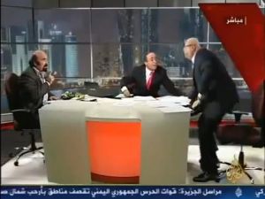 A still of the Al-Jazeera video that involves the altercation Lebanese pro-regime analyst Joseph Abu Fadel and Syrian opposition activist Muhieddine Ladkani on live television.