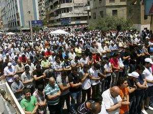 Supporters of Lebanon's radical Sunni cleric Sheikh Ahmad al-Assir perform the weekly Friday prayers as they gather to show their support to Assir in the southern city of Sidon on June 28, 2013. Lebanese security forces have launched a manhunt for Assir, after clashes with his supporters in Sidon killed 17 soldiers. (Source: AFP/MAHMOUD ZAYYAT)