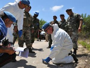 UN experts work at the scene of an explosion that wounded overnight four Israeli soldiers on patrol on August 7, 2013 inside the Lebanese territory along the border with Israel. (AFP)