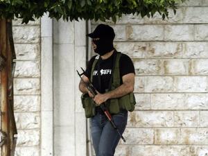 A masked anti-Hezbollah gunman  stands in the southern town of Sidon after bloody clashes, on Tuesday. AFP photo