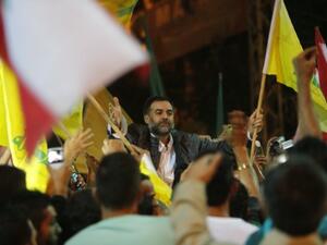 One of the nine Lebanese Shiite pilgrims abducted by rebels in Syria is greeted upon arrival in Bir al-Abed in the southern suburbs of Beirut on October 19, 2013, after being released in Turkey the previous day. (AFP)