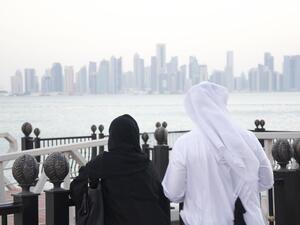 A man and woman look out at the Doha Skyline (Albawaba/J. Zach Hollo)