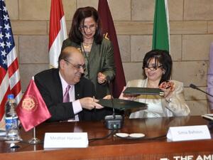 Medhat Haroun and Sima Bohous signing the MoU and behind them standing is Malak Zaalouk