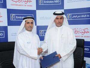 Mohammed Al Marri, Assistant Executive Director for Financial Affairs, MRHE and Jamal Bin Ghalaita, Group Deputy Chief Executive Officer, Emirates NBD, shaking hands after the signing