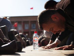 Praying at Parliament: Moroccans pray outside parliament as thousands protest against King Mohammed VI, February, 2011. 