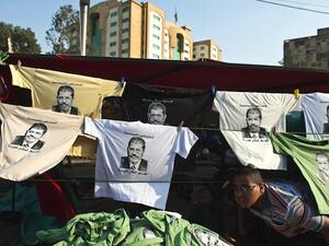 T-shirts bearing portraits of Egypt's deposed president Mohamed Morsi are put on display outside a tent during a sit-in organised by the Muslim Brotherhood in his support outside Rabaa al-Adawiya mosque in Cairo on August 4, 2013. (AFP)