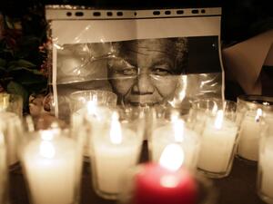 The UAE will host a heartfelt memorial to the late and great Nelson Mandela on Wednesday. Flowers are layed on December 6, 2013, on the ground in front of the South African Embassy in Paris. (AFP)