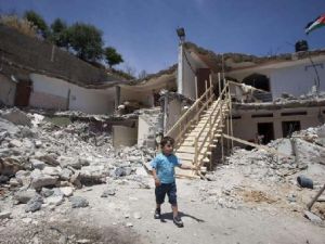 A Palestinian boy walks near the rubble of his family's destroyed house after Israeli bulldozers razed it down the previous day in the east Jerusalem neighborhood of Jabal Mukabbir in May. AFP Photo