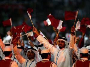 Qataris raise their heads and their flags with pride.