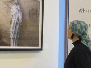 Saudi Princess Reem Al Faisal looks at a picture taken by a photographer exhibiting his work in her gallery in Dubai. (Jumana Al Tamimi/Gulf News)