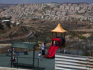  A Jewish woman looks after children at a play ground in the Jewish settlement of Beitar Elit at the Israeli occupied West Bank on August 12, 2013. (AFP)
