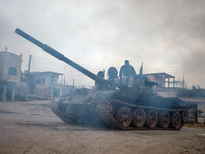 Syrian rebels drive a T-72 tank, captured from government forces two months ago, in the village of Kfarruma in the flashpoint Syrian province of Idlib near the border with Turkey, on Monday (AFP Photo/Daniel Leal-Olivas)