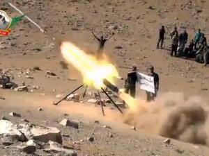 An image grab taken from a video uploaded on YouTube on May 29, 2013 allegedly shows members of the Al-Tawhid brigade firing missiles from Syria towards the Lebanese town of Hermel, a few kilometres from Baalbek in the Bekaa valley. (AFP)